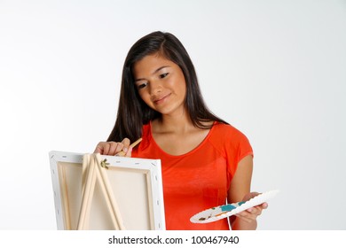 Teen Painting A Canvas On White Background