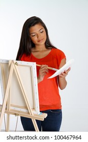 Teen Painting A Canvas On White Background