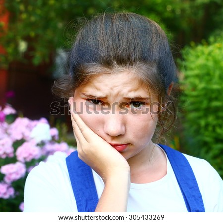 teen pretty girl with toothache outdoor portrait
