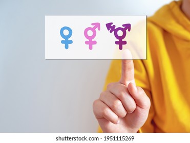 Teen Problem Family Issues Gender Confusion In Teenager.  A Teen Boy Pointing At Gender Symbols Of Male Bigender And Transgender. Concept Of Choice Gender Confusion Or Dysphoria. 