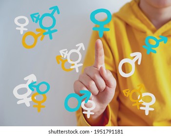 Teen Problem Family Issues Gender Confusion In Teenager.  A Teen Boy Pointing At Gender Symbols Of Male Bigender And Transgender. Concept Of Choice Gender Confusion Or Dysphoria. 