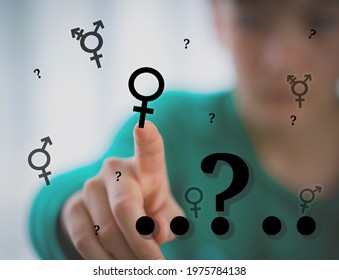 Teen Problem Family Issues Gender Confusion In Teenager. A Teen Boy Pointing At Gender Symbols Of Male Bigender And Transgender. Concept Of Choice Gender Confusion Or Dysphoria.