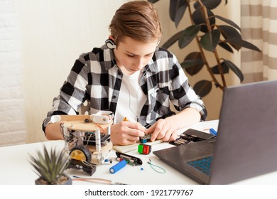 Teen Programming And Building Science Robotics Project On His Laptop At Home During Covid-19 Pandemic Lockdown. STEM Education , Remote Learning, Technology Concept