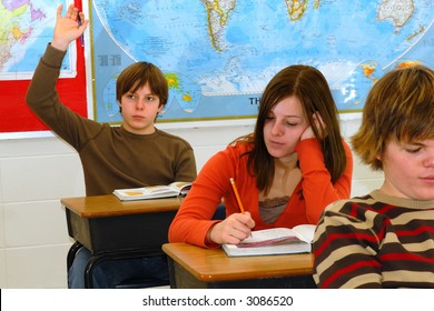 A teen raises hand in classroom