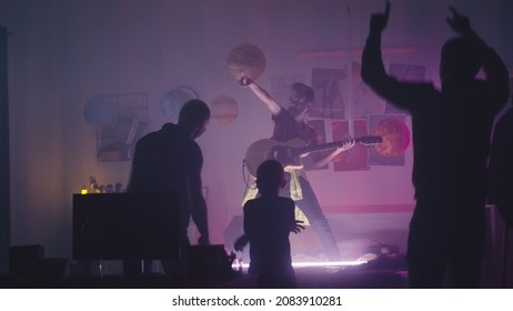 Teen Rocker Playing Guitar For Family