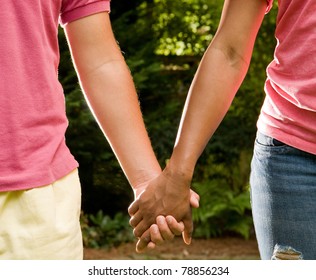 Teen Romance - Hispanic Boy And African American Girl Holding Hands