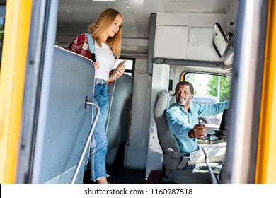 Teen Schoolgirl  Walking By School Bus While Senior Driver Smiling To Her