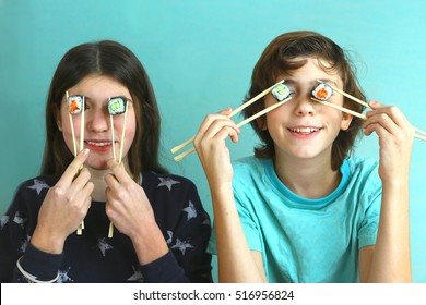 Teen Siblings Boy And Girl Kids With Sushi Rolls Avocado And Salmon Close Up Smiling Photo, Brother And Sister Eating Sushi Rolls