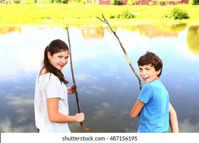 teen siblings kids boy and girl fishing on the lake close up photo