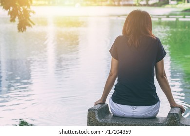 Teen Sitting Alone Feeling Lonely And Thinking Missing Someone Looking Out At Water Lake