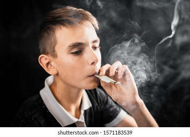 Teen Smoking A Cigarette Or Drugs Is A Rolled Up Dollar, The Concept Of Teen Addiction And Spending Money On Cigarettes, Horror