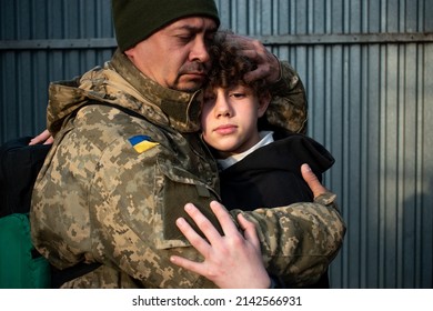 Teen son says goodbye to her military father. Son hugs a dad Ukrainian soldier. Ukrainian defender says goodbye to his family. Mobilization of Ukrainian men. War in Ukraine. Defenders of Ukraine