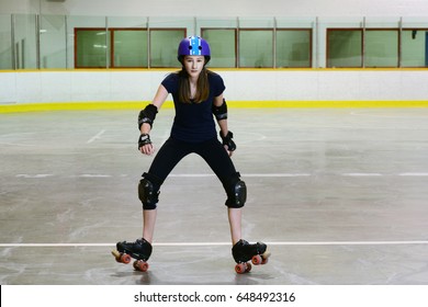 Teen Standing On Back Wheels On Quad Roller Skates