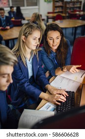 Teen Student Is Working With Her Teacher On The Computer During Her Lesson. They Are Discussing Something On The Computer.