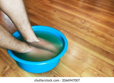 Teen Taking A Healing Warming Foot Bath With Mustard Powder, 
Against Cold Illness, Aches And Improves Blood Circulation. Alternative Medicine.