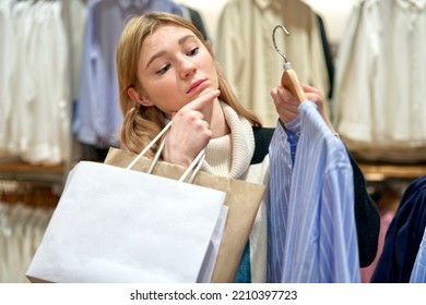 Teen Teenager Girl, Young Beautiful Pretty Woman In Mall, Shopping With Bags Choosing Clothes In Boutique. Shopaholic Lady Customer Buying In Shop, Store. Choice