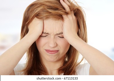 Teen Woman With Headache Holding Her Hand To The Head