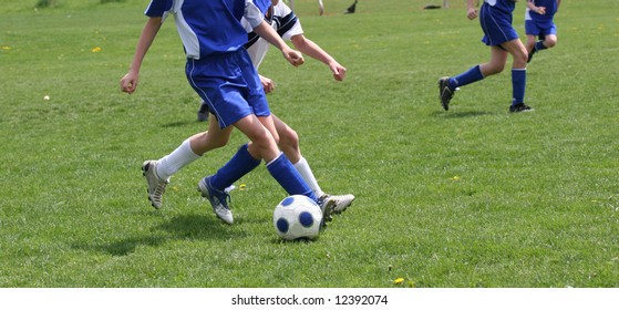 Teen Youth Kicking Soccer Ball At Game