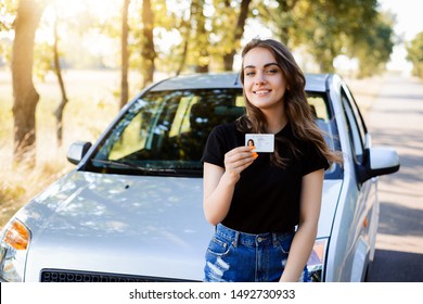Teenader is happy to receive driving licence. Concept of buying first car
