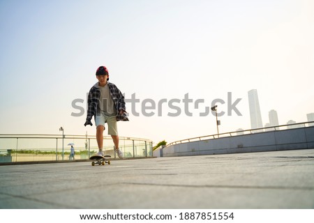 Similar – teenager practicing with skateboard at sunrise city