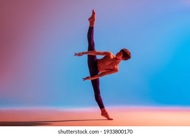 teenage ballet dancer dances barefoot under a colored light. - Powered by Shutterstock