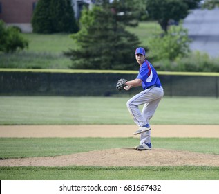 Teenage Baseball Pitcher Winding Up On The Pitchers Mound.