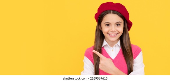 Teenage Beauty. Tween And Youth. Casual Fashion. Happy French Teen Girl Pointing Finger. Child Face, Horizontal Poster, Teenager Girl Isolated Portrait, Banner With Copy Space.