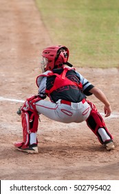 Teenage Boy Catching Behind Home Plate