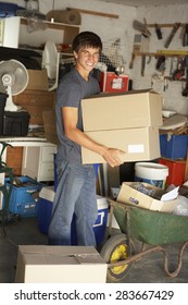 Teenage Boy Clearing Garage For Yard Sale