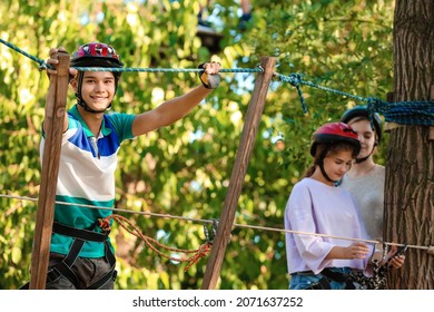 Teenage Boy Climbing In Adventure Park