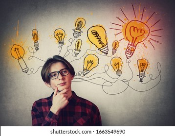 Teenage boy confident thinking, glowing light bulbs over head. Student guy dreamer wearing glasses, has different thoughts. Genius creativity concept, brilliant ideas are the way to success.