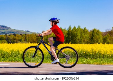 Teenage Boy Cycling On Country Road
