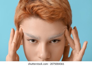 Teenage Boy With Dyed Eyebrows On Color Background