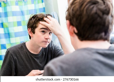 Teenage Boy Getting Ready For School In The Morning.