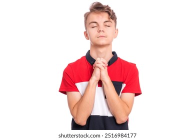 A teenage boy with his hands clasped together, eyes closed, in a praying gesture. Wearing a red and black shirt, isolated on a white background. - Powered by Shutterstock