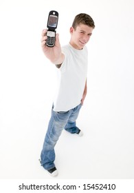 Teenage Boy Holding Up Cellular Phone And Smiling