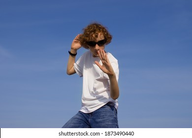 A Teenage Boy In A Karate Pose Outdoors