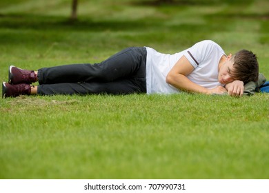 Teenage Boy Laying On Grass On Stock Photo (Edit Now) 707990731