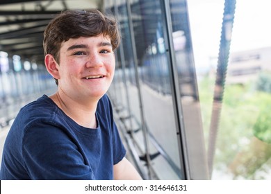 Teenage boy at the lightrail station in urban area.