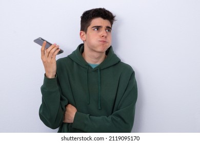 Teenage Boy Listening To Stressful Voice Message Isolated In Blank