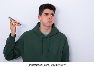 Teenage Boy Listening To Stressful Voice Message Isolated In Blank