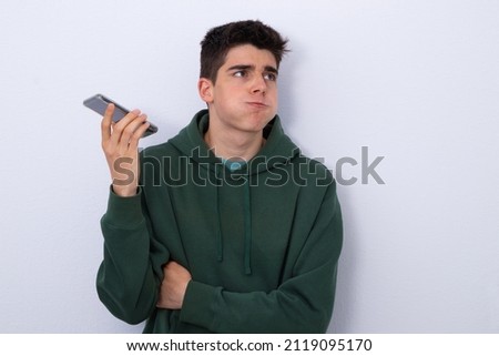 teenage boy listening to stressful voice message isolated in blank Stock photo © 