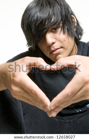 Teenage boy making heart symbol with hands