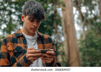 teenage boy with mobile phone outdoors