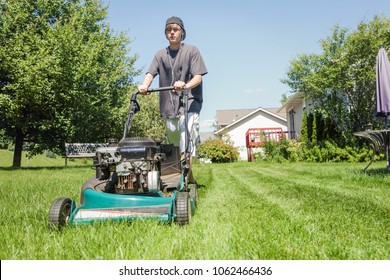 Teenage Boy Mowing Lawn