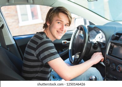 A Teenage Boy And New Driver Behind Wheel Of His Car