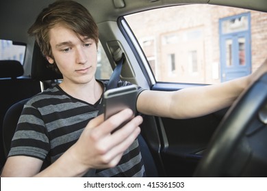 A Teenage Boy And New Driver Behind Wheel Of His Car 