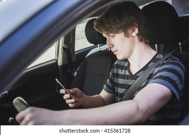 A Teenage Boy And New Driver Behind Wheel Of His Car 