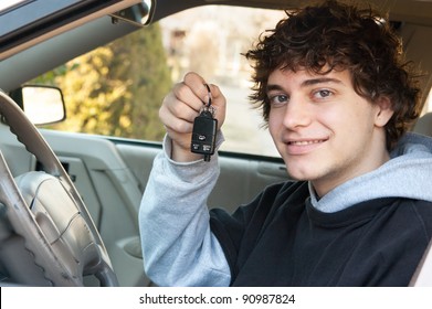 Teenage Boy And New Driver Behind Wheel Of His Car Holding Keys