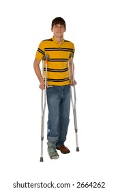 Teenage boy on crutches with his right foot in a softcast brace isolated on a white background.